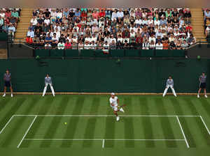 Japan's Sho Shimabukuro returns the ball to Bulgaria's Grigor Dimitrov during their men's singles tennis match on the third day of the 2023 Wimbledon Championships at The All England Tennis Club in Wimbledon, southwest London, on July 5, 2023.  RESTRICTED TO EDITORIAL USE (Photo by Adrian DENNIS / AFP) / RESTRICTED TO EDITORIAL USE