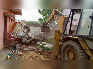 **EDS: GRAB FROM PTI VIDEO** Sidhi: A bulldozer being used to demolish the house...