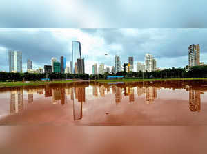 Mumbai, July 07 (ANI): A reflection of high-rise building is seen on the puddle ...