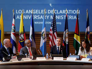 US Secretary of Homeland Security Alejandro Mayorkas (L) and Under Secretary of State for Civilian Security, Democracy, and Human Rights Uzra Zeya (R) attend the Anniversary Ministerial of the Los Angeles Declaration on Migration and Protection co-hosted by Belize Foreign Minister Eamon Courtenay (C) and US Secretary of State Antony Blinken (R), at the World Bank headquarters in Washington, DC, on June 23, 2023.  (Photo by SAMUEL CORUM / AFP)