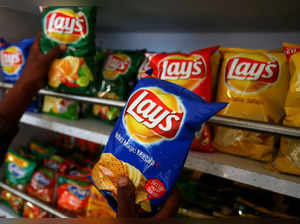 A customer picks packets of Lay's potato chips at a shop in Ahmedabad