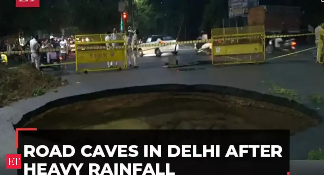 delhi: Delhi Rains: Road caves in Rohini after heavy rainfall, no injuries reported - The Economic Times Video | ET Now