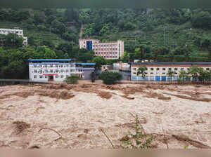 This photo taken on July 4, 2023 shows the water of an overflowing river flooding an area at the Wanzhou district in China's southwestern Chongqing. China OUT (Photo by AFP)