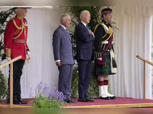US President Joe Biden stands with Britain's King Charles III during a ceremony ...