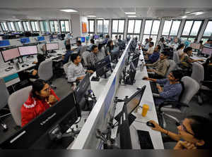 Employees work on their terminals inside the office of Manubhai & Shah LLP in Ahmedabad