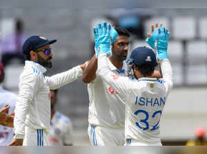 Ravichandran Ashwin (C), Ishant Sharma (R) and Virat Kohli (L) of India celebrate the dismissal of Tagenarine Chanderpaul of West Indies during day one of the 1st Test between West Indies and India at Windsor Park, Roseau, Dominica, on July 12, 2023.  (Photo by Randy Brooks / AFP)
