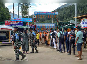 Pahalgam: Security personnel stand guard as the first batch of Amarnath Yatra pi...