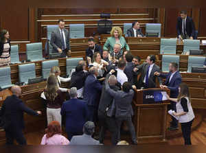 Kosovo opposition lawmakers clash with ruling members in the Kosovo parliament on July 13, 2023 during a heated debate over measures aimed at defusing tensions in restive Serb enclaves in the north. The melee kicked off as Prime Minister Albin Kurti addressed the house and was doused with water by a rival lawmaker.  (Photo by AFP)