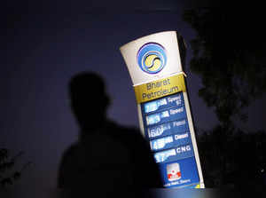 FILE PHOTO: A Bharat Petroleum oil pump station displays the price of unleaded petrol and Diesel as a pedestrian walks past in New Delhi