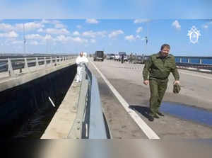 This video grab taken and released on July 17, 2023 by the Russian Investigative Commitee shows committee investigators working on the Kerch bridge -- linking Crimea to Russia -- which was heavily damaged following an attack. Russia on July 17, 2023, said a Ukrainian attack on the bridge linking Moscow-annexed Crimea to the Russian mainland killed a civilian couple and wounded their child.  - RESTRICTED TO EDITORIAL USE - MANDATORY CREDIT "AFP PHOTO / RUSSIAN INVESTIGATIVE COMMITTEE  " - NO MARKETING NO ADVERTISING CAMPAIGNS - DISTRIBUTED AS A SERVICE TO CLIENTS (Photo by RUSSIAN INVESTIGATIVE COMMITTEE / AFP)