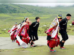 Tawang [Arunachal Pradesh], July 17 (ANI): Local graziers dressed in traditional...