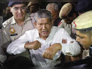New Delhi: Congress leader Harish Rawat being detained by Delhi Police during the 'Loktantra Bachao Mashaal Shanti March' at Red Fort in New Delhi on Tuesday, March 28, 2023. (Photo: IANS/Wasim Sarvar)
