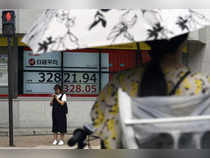 Japan's Nikkei scales two-week peak on Wall Street rally, dovish BOJ