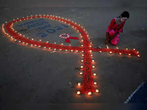 FILE PHOTO: A girl lights earthen lamps during an HIV/AIDS awareness campaign on the occasion of World AIDS Day in Kolkata
