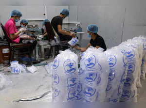 Workers fill bags with cubes of ice at a factory, in Sanaa