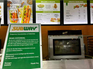 A notice on the temporary unavailability of tomatoes is seen at a Subway outlet at an airport terminal in New Delhi