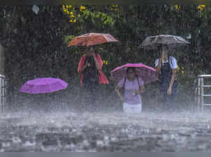 Kochi: Pedestrians during monsoon rainfall, in Kochi. (PTI Photo)(...