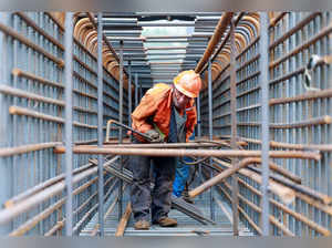 A worker prepares steel bars on the construction site of the Zhangjinggao Yangtze River Bridge on Mazhou Island in Jingjiang, in China’s eastern Jiangsu province on July 14, 2023.  - China OUT (Photo by STRINGER / AFP)