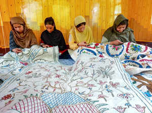 **EDS: TO GO WITH STORY** Srinagar: Women artisans make a Namda, the famed Kashm...