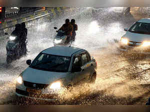 Hyderabad: Vehicles move on a road during monsoon rain in Hyderabad. (PTI Photo)...