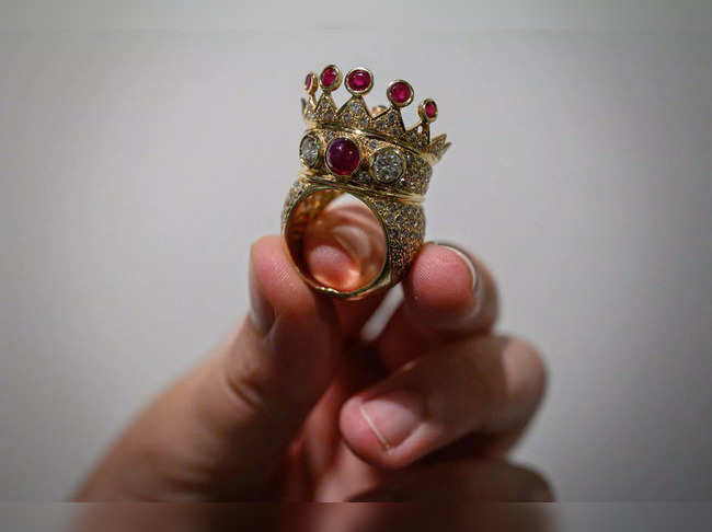 (FILES) A gold, ruby, and diamond crown ring, designed and worn by the late US rapper Tupac Shakur during his last public appearance in 1996, is displayed during a press preview at Sotheby's in New York City on July 20, 2023. A gold, ruby and diamond crown ring worn by rap legend Tupac Shakur during his last public appearance sold for $1 million at auction in New York on July 25, 2023. The winning bid was well above Sotheby's pre-sale estimate of between $200,000 and $300,000 and becomes the most valuable hip-hop artifact ever sold, the auction house said. (Photo