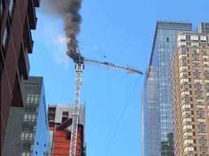 New York City: Construction crane partially collapses after catching fire; 2 injured