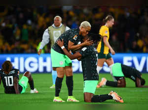 Nigeria's defender #05 Onome Ebi (L) and Nigeria's defender #03 Osinachi Ohale celebrate their team's victory after the end of the Australia and New Zealand 2023 Women's World Cup Group B football match between Australia and Nigeria at Brisbane Stadium in Brisbane on July 27, 2023.  (Photo by Patrick Hamilton / AFP)