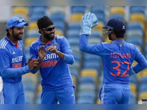 India's Ravindra Jadeja, center, celebrates with captain Rohit Sharma and week k...