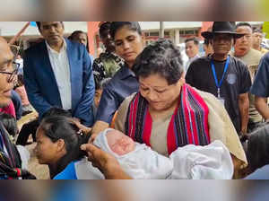 **EDS: VIDEO GRAB** Churachandpur: Manipur Governor Anusuiya Uikey with a child ...
