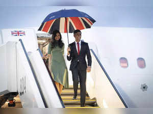 Britain's Prime Minister Rishi Sunak, right, and his wife Akshata Murty arrive b...