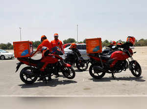 Delivery riders arrive to one of the climate-controlled area in Abu Dhabi