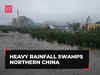 Heavy rainfall swamps northern China; streets flooded, cars washed away; Beijing issues red alert