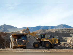 A wheel loader operator fills a truck with ore at the MP Materials rare earth mine in Mountain Pass
