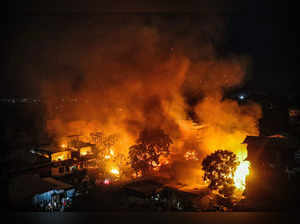 Imphal: Smoke and flame billows out after the houses of Kuki-Zo community were s...