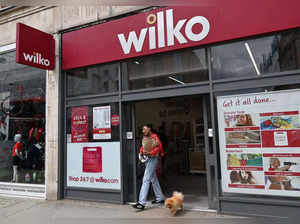 A shopper leaves a branch of "Wilko" in west London on August 3, 2023. Wilko, August 3, has said it intends to appoint administrators, potentially putting up to 12,000 jobs at the high street retailer at risk. (Photo by JUSTIN TALLIS / AFP)