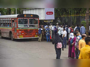 Mumbai: Passengers board a bus at a stop as strike by drivers of private bus ope...