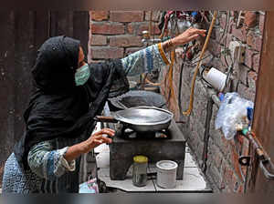 In this picture taken on July 25, 2023, Lubna Babar, a former factory worker cooks during an interview with AFP at her house in Lahore. Factory worker Lubna Babar was made redundant at the beginning of the year, a victim of a crisis in the Pakistan textile industry that has seen it lose ground to more nimble Asian competitors. Pakistan's industrial manufacturing sector -- like elsewhere in the world -- has suffered from the slowdown in global consumption and the rise in energy costs following the outbreak of war in Ukraine. - XGTY / TO GO WITH 'Pakitan-economy-textiles' FOCUS by