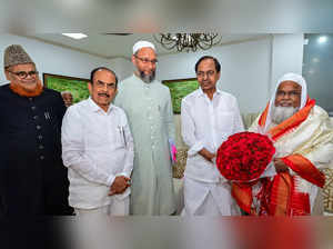 Hyderabad: Telangana CM K Chandrasekhar Rao with AIMIM President Asaduddin Owais...