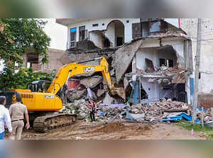 Nuh: Bulldozer being used to demolish the 'illegally constructed' Sahara hotel i...
