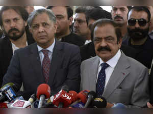 Pakistan's Interior Minister Rana Sanaullah, right, and Law Minister Azam Nazeer...