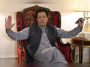 Pakistan's former prime minister Imran Khan talks with reporters regarding the c...