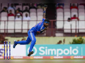 India's captain Hardik Pandya bowls against West Indies during their second T20 ...
