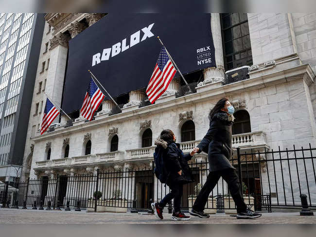 A child looks back at a banner for Roblox, displayed to celebrate the company's IPO at the NYSE is seen in New York