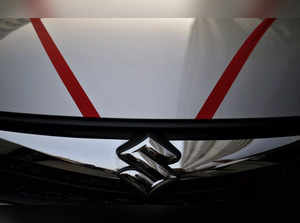 FILE PHOTO: The logo of Maruti Suzuki India Limited is seen on car parked outside a showroom in New Delhi