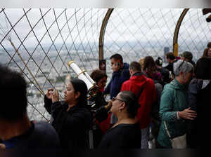 Tourists visit the Eiffel Tower in Paris