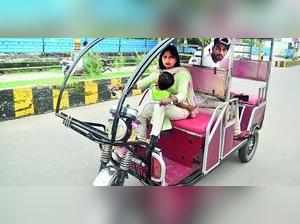 Baby strapped to waist, woman drives e-rickshaw for a living in Amroha
