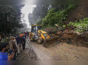 Shimla: An earthmover removes debris after a landslide on the Shimla-Chandigarh ...