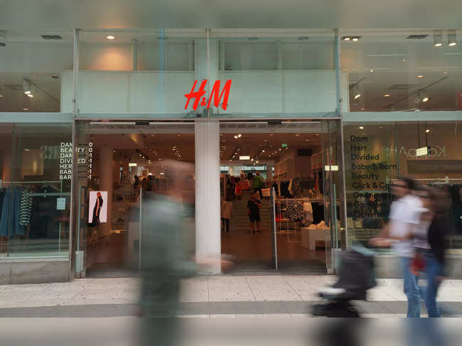 FILE PHOTO: Pedestrians and shoppers walk past a branch of fashion retailer H&M in central Stockholm