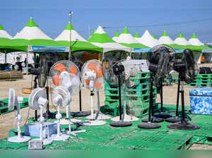 Electric fans are seen as scouts leave the World Scout Jamboree in Buan, North Jeolla province on August 8, 2023.  Tens of thousands of scouts were being evacuated from their problem-plagued South Korean campsite on August 8 ahead of a typhoon, as the scout chief said the challenges were unprecedented in a century of global jamborees.  (Photo by ANTHONY WALLACE / AFP)