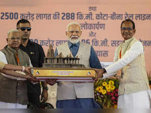 Sagar: Prime Minister Narendra Modi being presented a memento by Madhya Pradesh ...